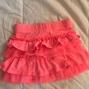 Girls ruffle skirt with coral color.